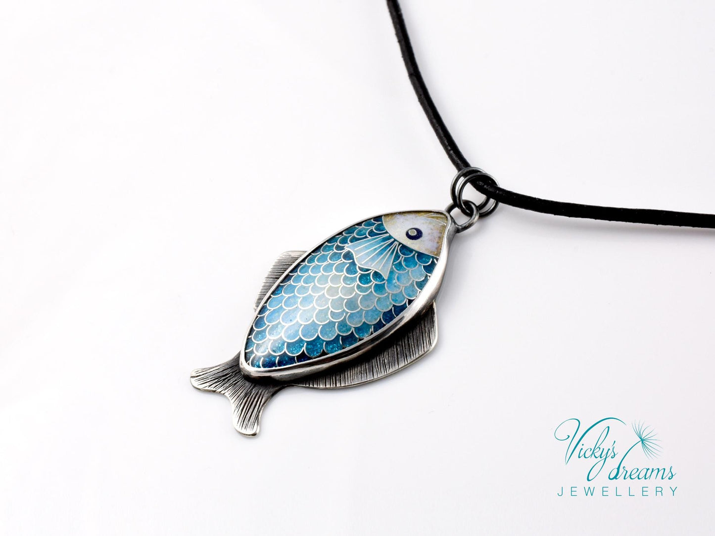 Hand-painted cloisonné enamel blue fish pendant in sterling silver setting.