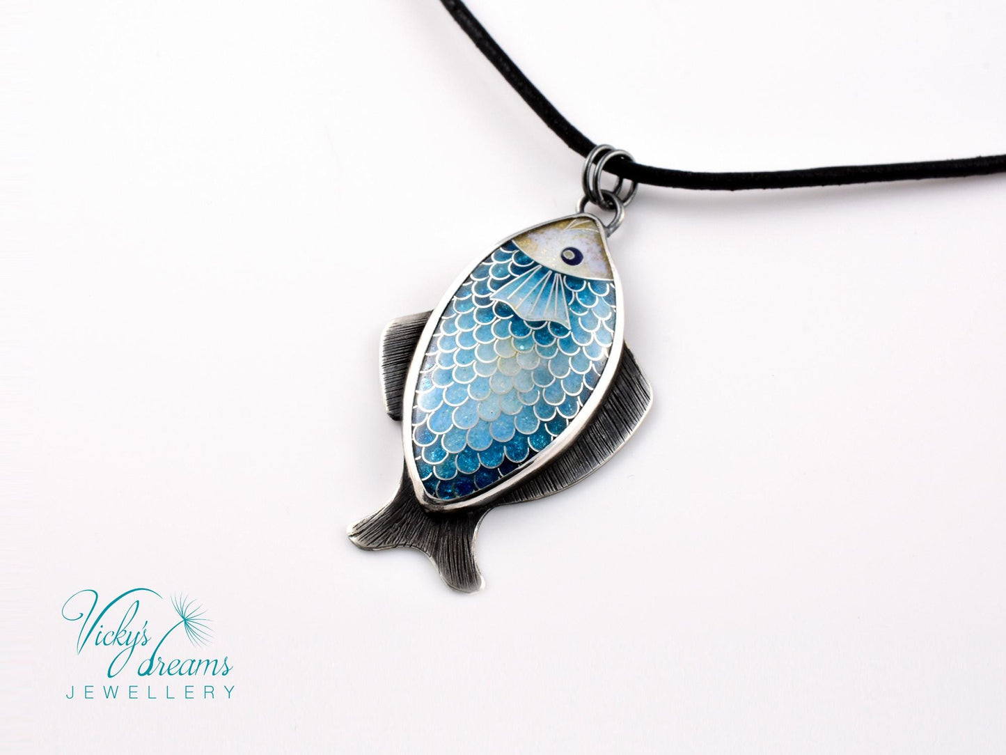 Hand-painted cloisonné enamel blue fish pendant in sterling silver setting.