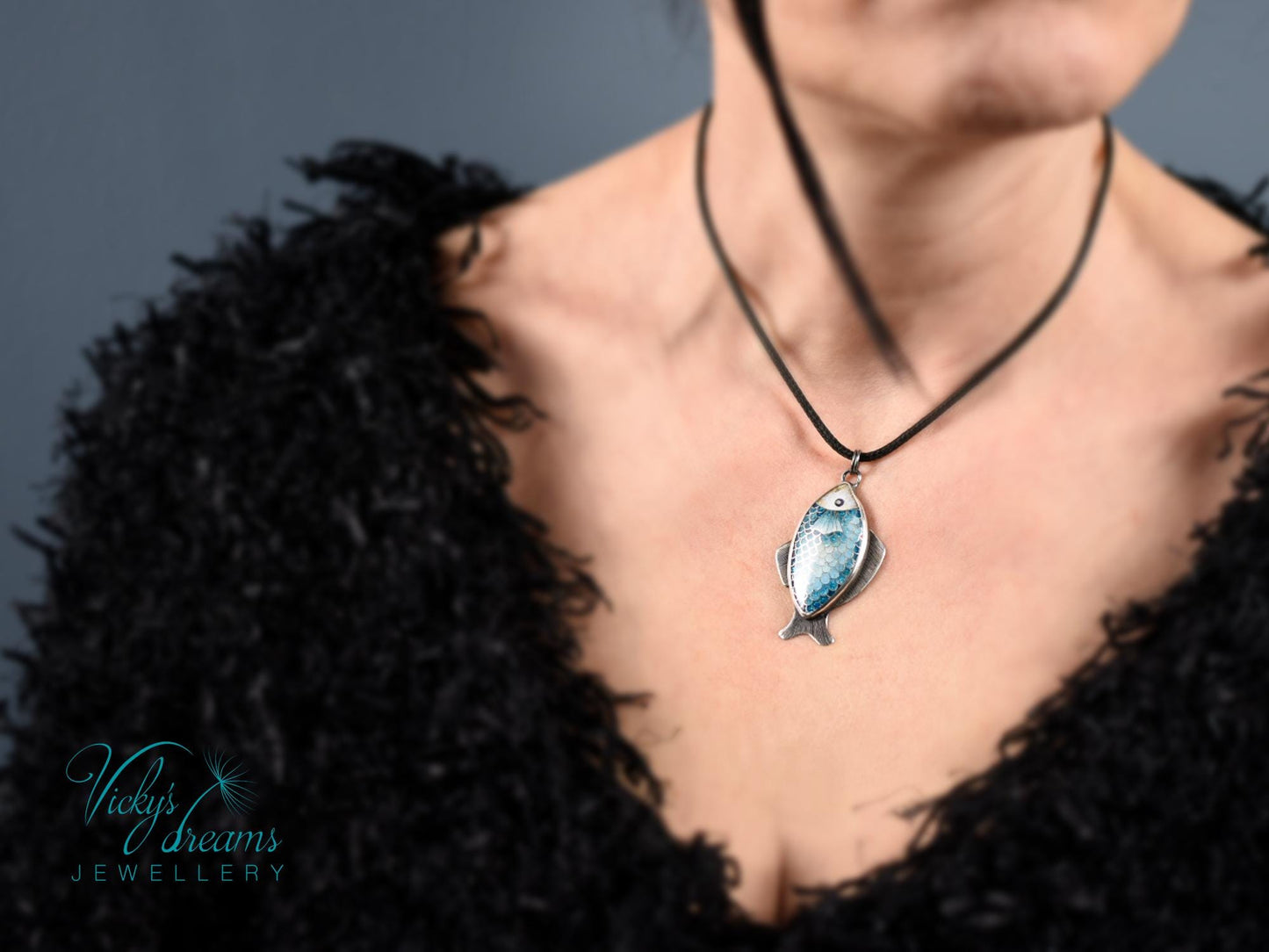 Hand-painted cloisonné enamel blue fish pendant in sterling silver setting.