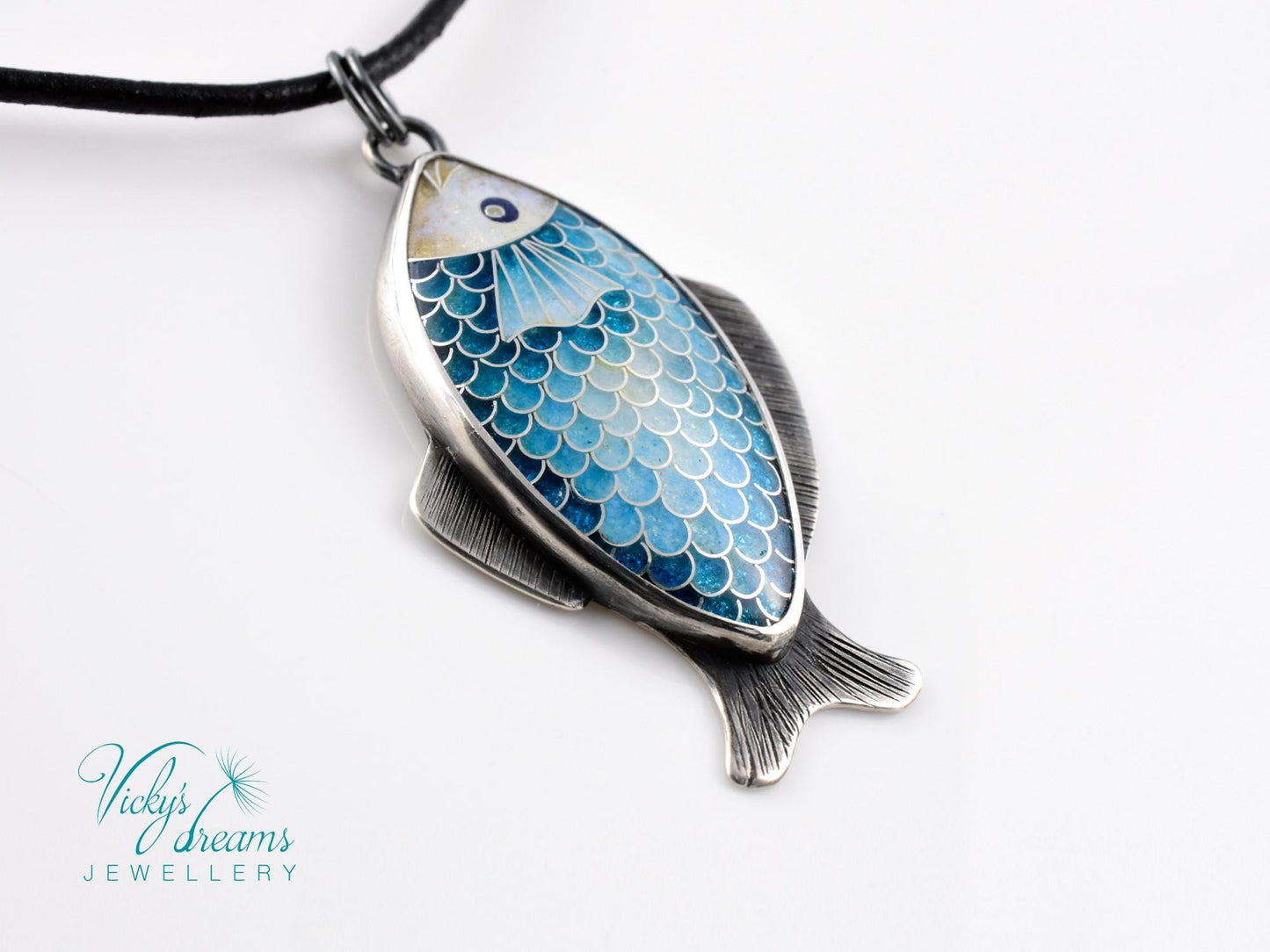 Hand-painted cloisonné enamel blue fish pendant in sterling silver setting.