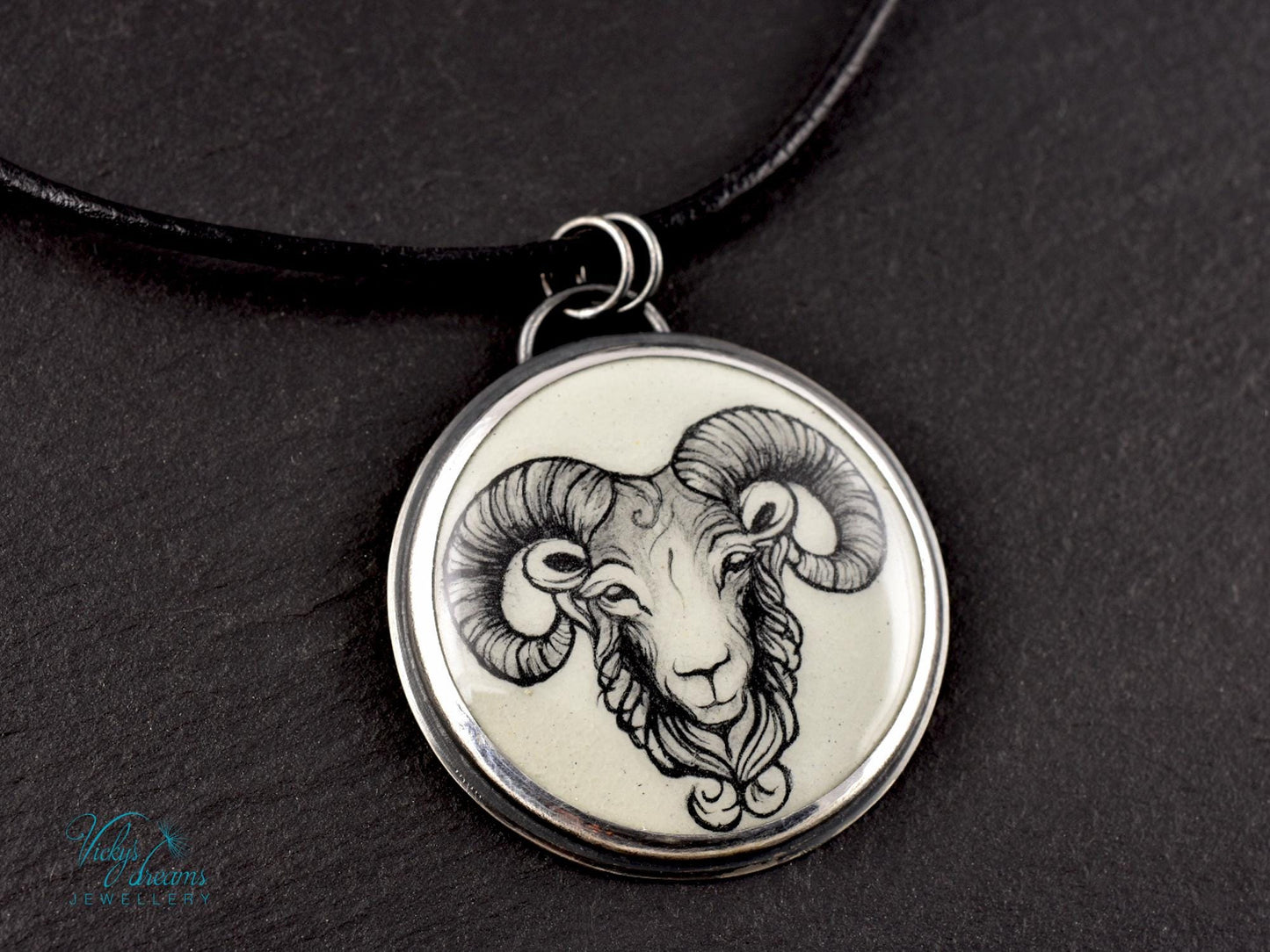 Hand-painted cloisonné enamel pendant featuring a zodiac sign design, set in sterling silver.