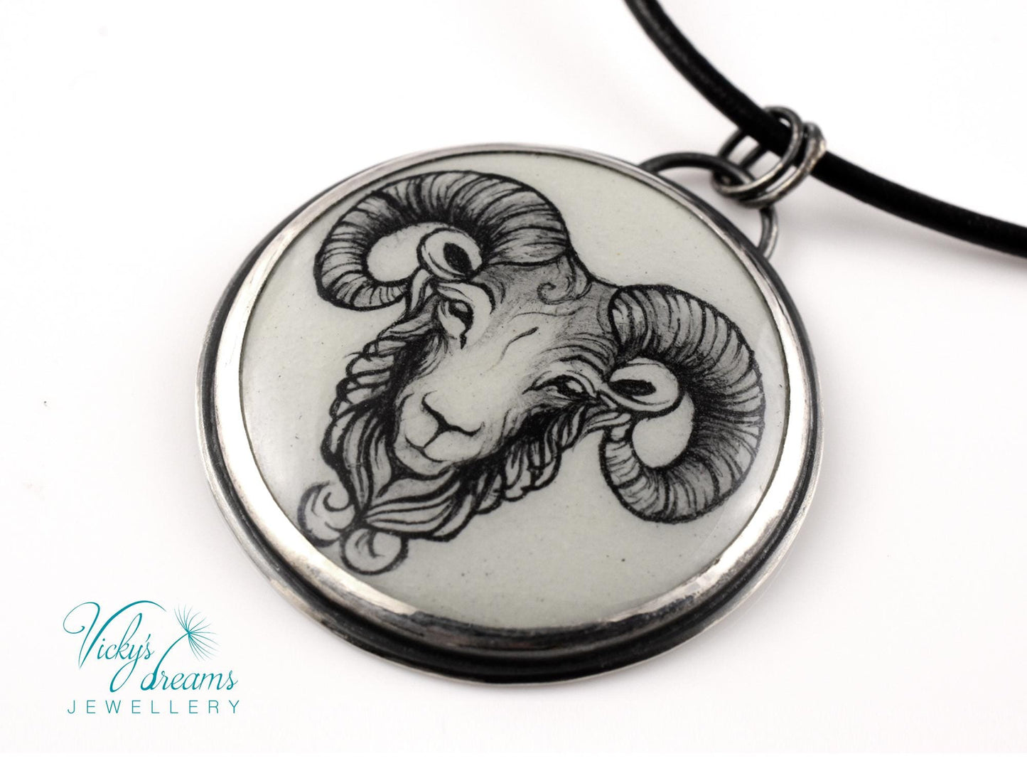 Hand-painted cloisonné enamel pendant featuring a zodiac sign design, set in sterling silver.
