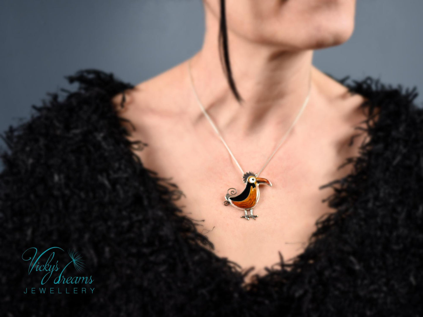Handcrafted boho birdie pendant with cloisonné enamel and sterling silver frame, unique nature-inspired jewelry piece.