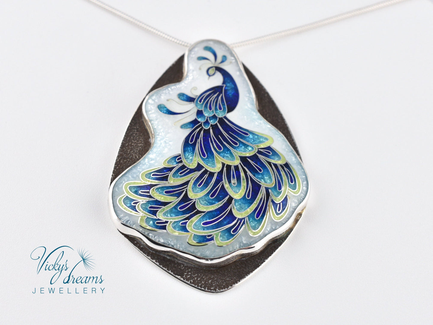 Handmade sterling silver peacock pendant with colorful enamel and artistic design.