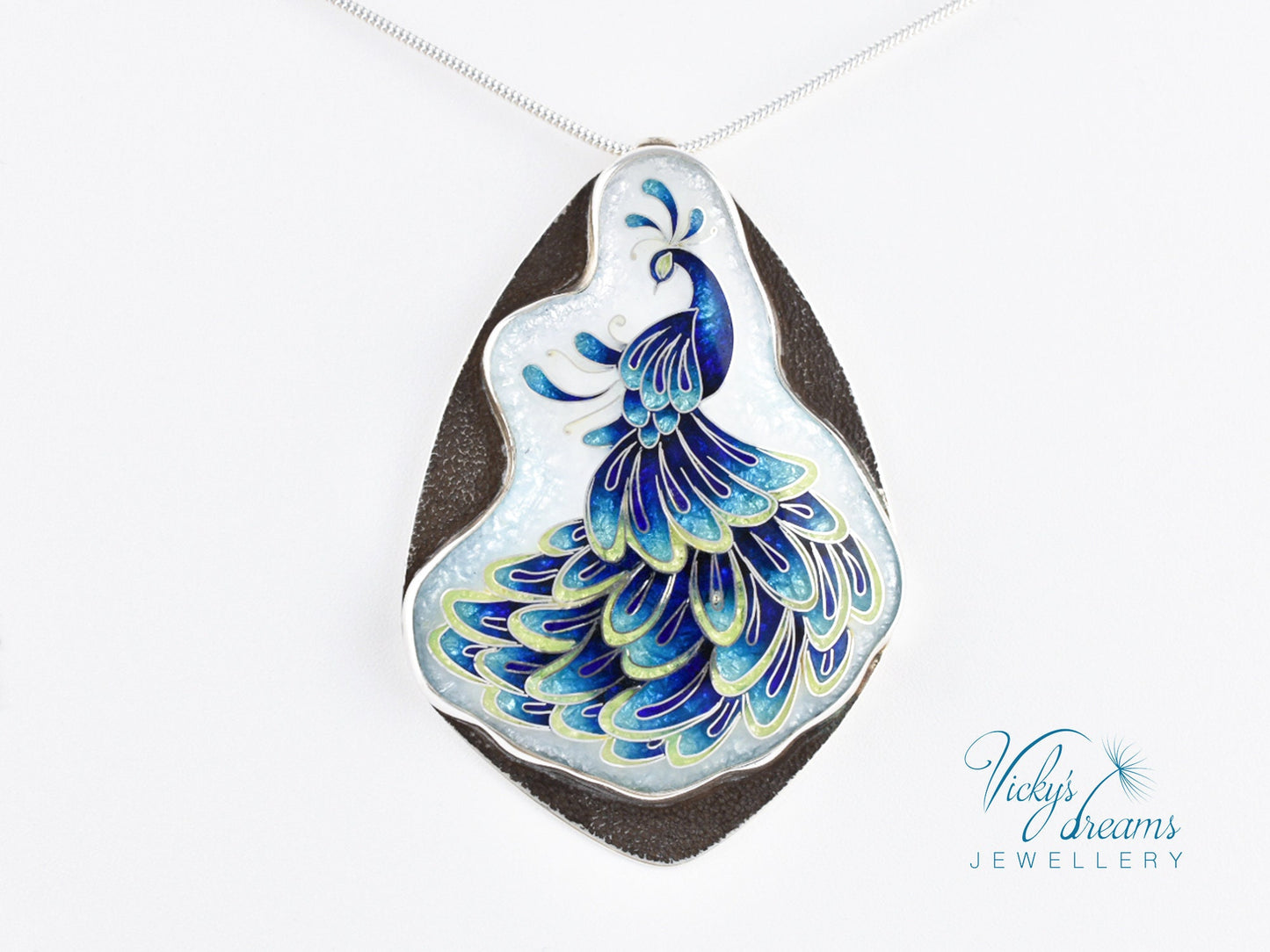 Handmade sterling silver peacock pendant with colorful enamel and artistic design.