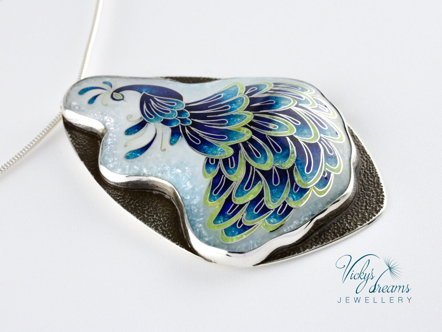Handmade sterling silver peacock pendant with colorful enamel and artistic design.
