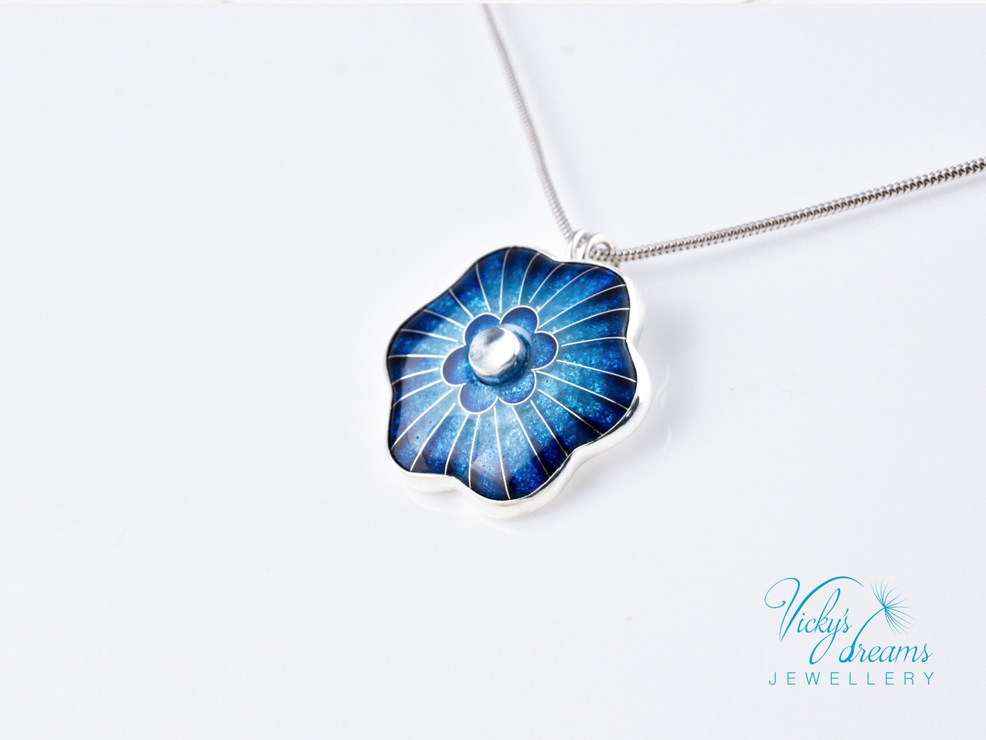 Cloisonné blue flower pendant with natural sky blue topaz set in sterling silver.