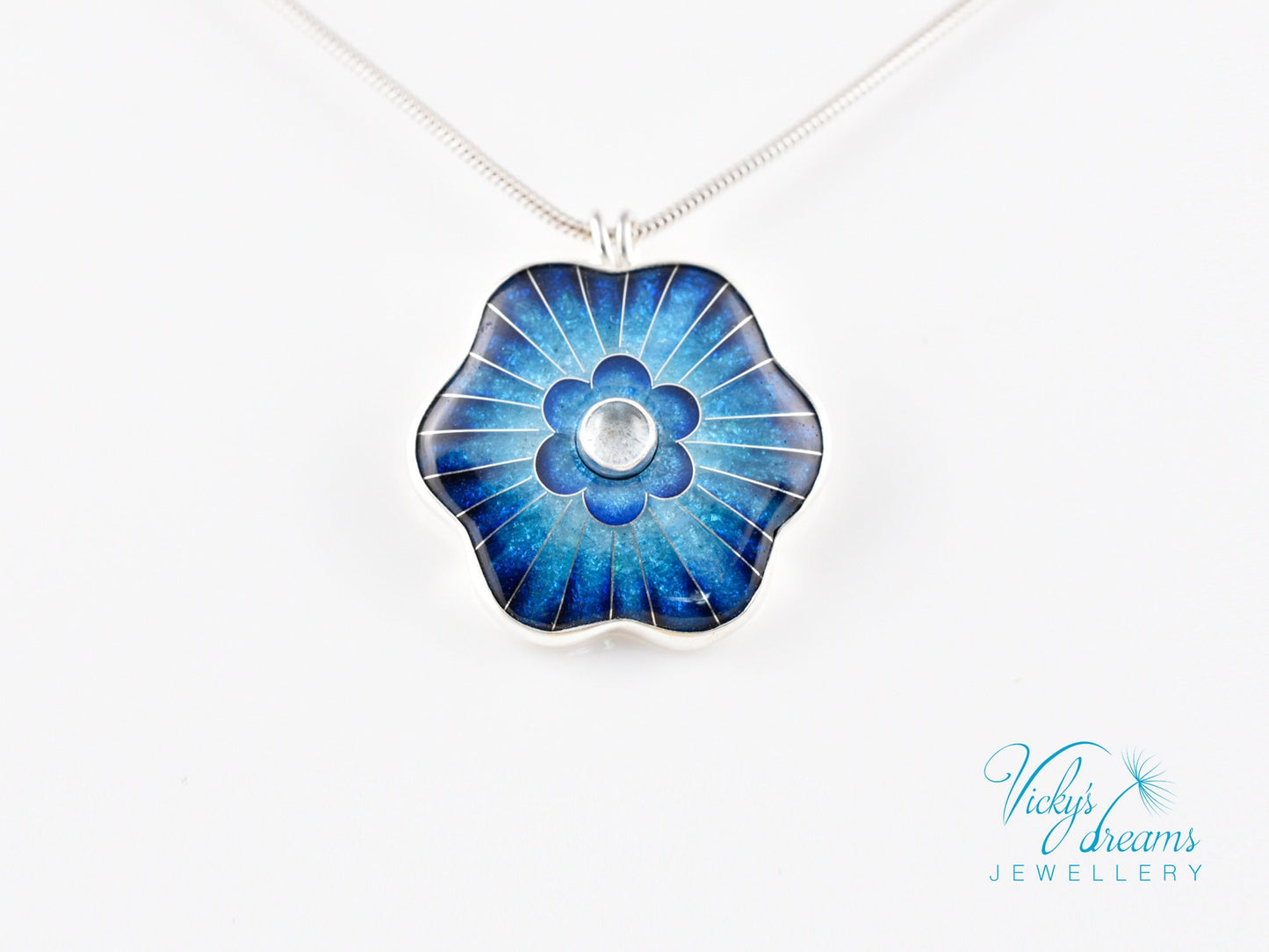 Cloisonné blue flower pendant with natural sky blue topaz set in sterling silver.
