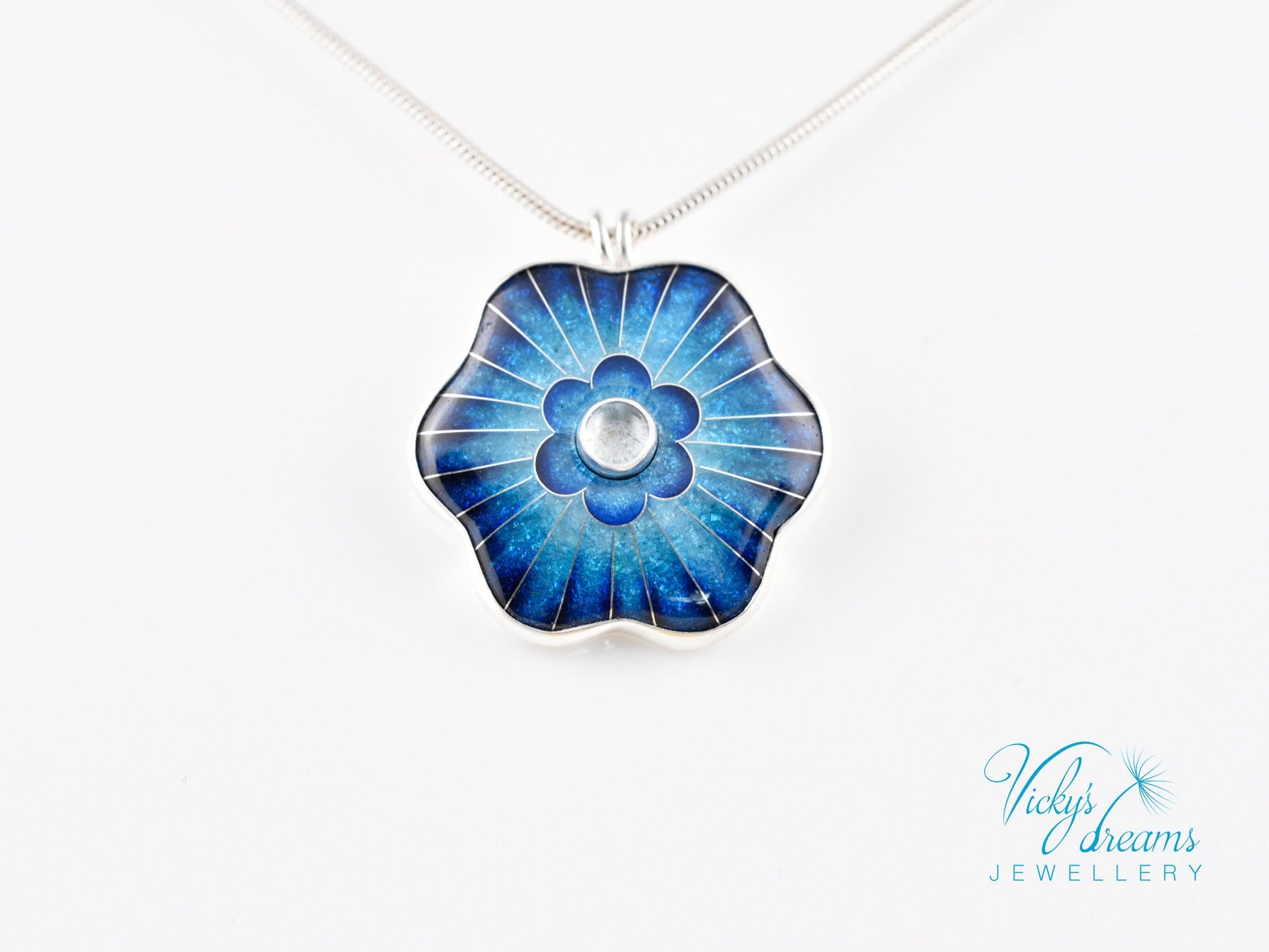 Cloisonné blue flower pendant with natural sky blue topaz set in sterling silver.