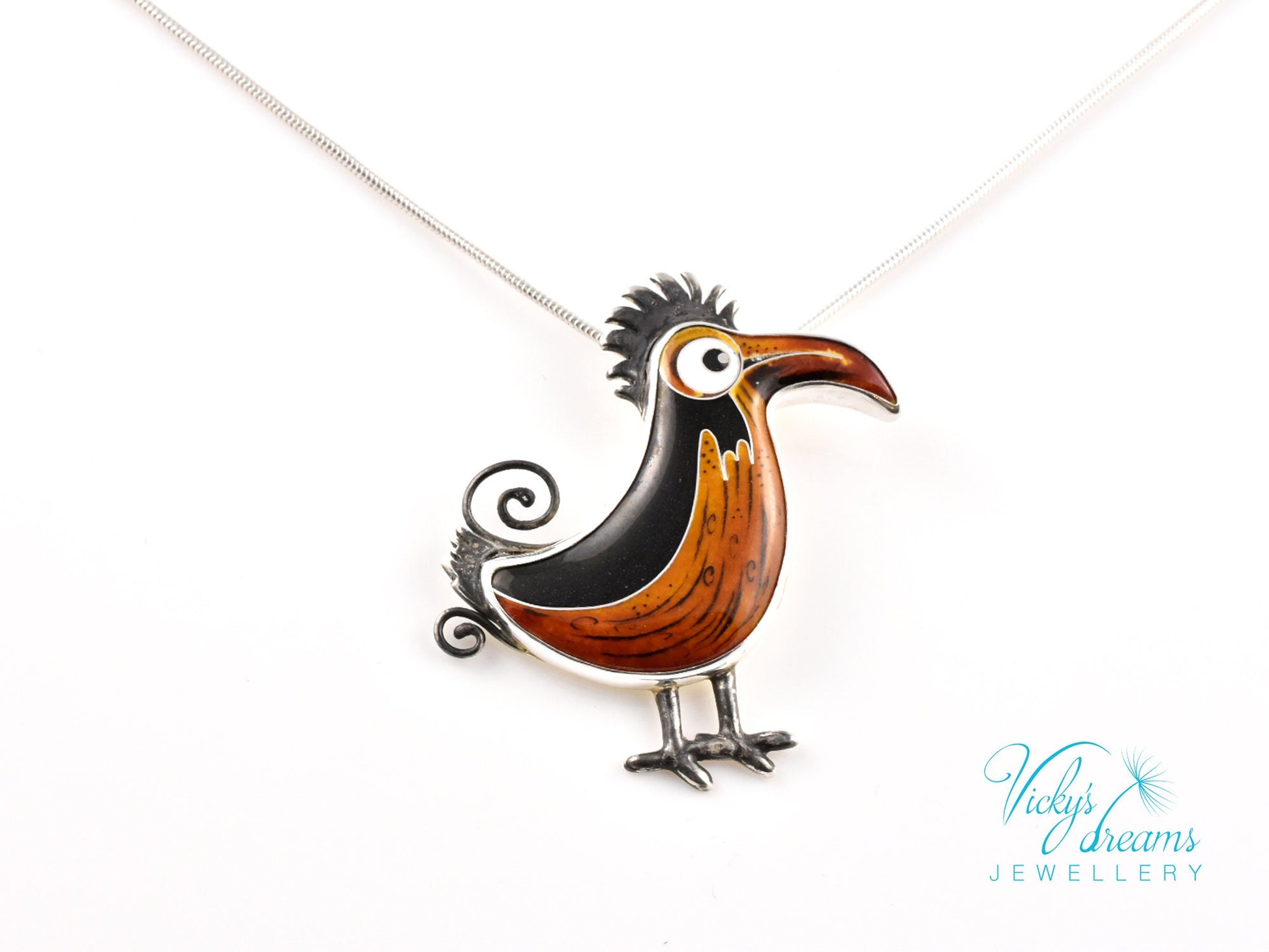 Handcrafted boho birdie pendant with cloisonné enamel and sterling silver frame, unique nature-inspired jewelry piece.